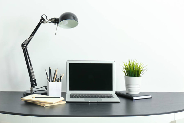 Comfortable home workplace with laptop on table - 写真・画像
