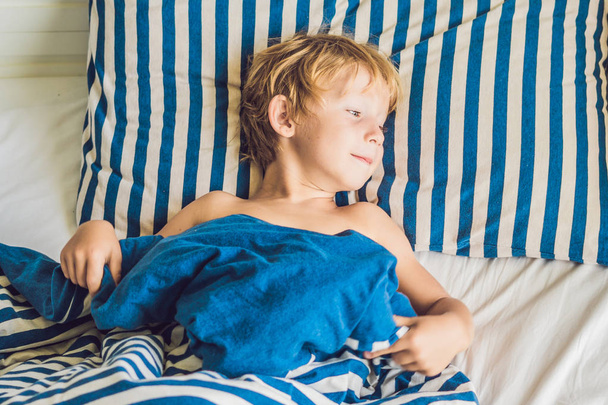 Cute little boy waking up in bed. Children sleep concept - Foto, imagen