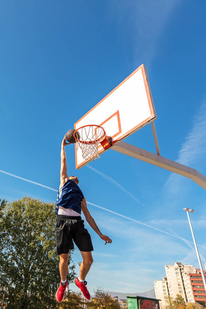 Young Basketball street player making slam dunk - Photo, Image