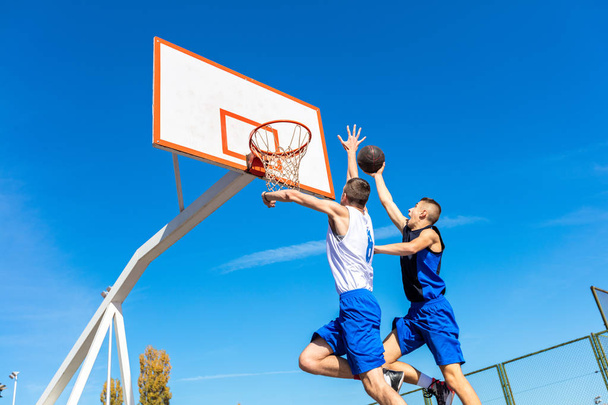 Young Basketball street player making slam dunk - Zdjęcie, obraz