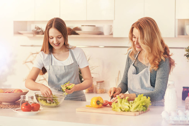 Delighted female family members preparing dinner - Фото, зображення