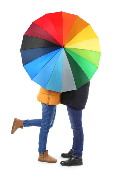 Young romantic couple with colorful umbrella on white background - Foto, immagini