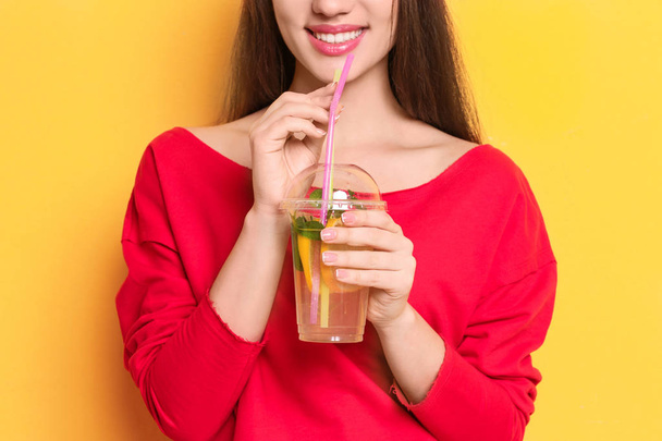Young woman with tasty lemonade - 写真・画像
