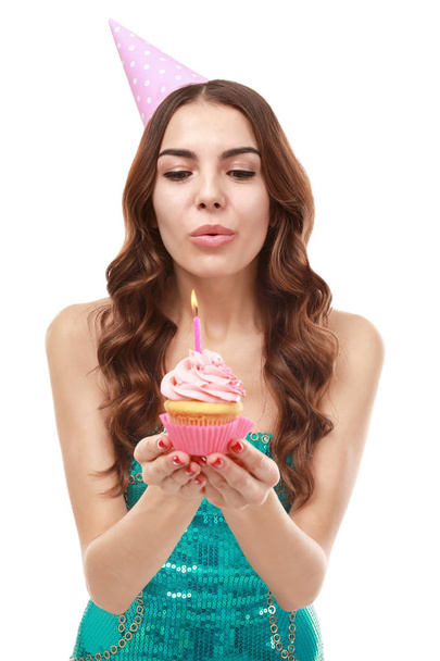 young woman snuffing out candle  - Photo, image