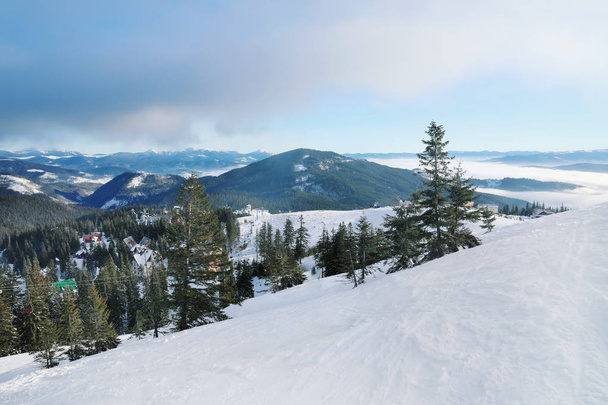 Snowy ski resort in mountains on winter day - 写真・画像