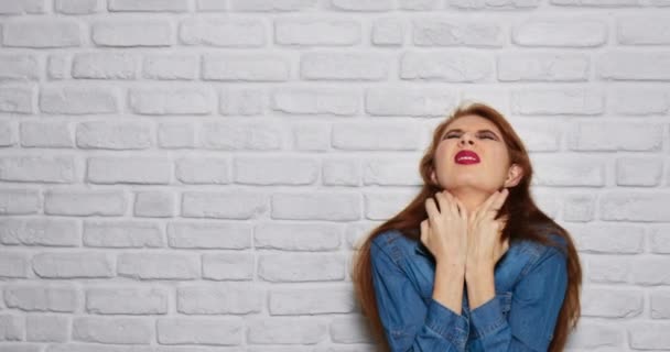 Facial Expressions Of Young Redhead Woman On Brick Wall - Footage, Video