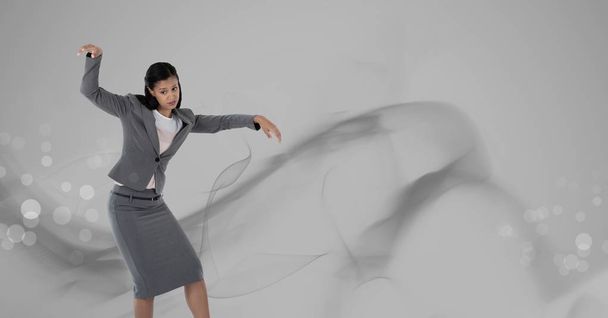 Digital composite of Woman dancing with grey smoke swirls - Valokuva, kuva