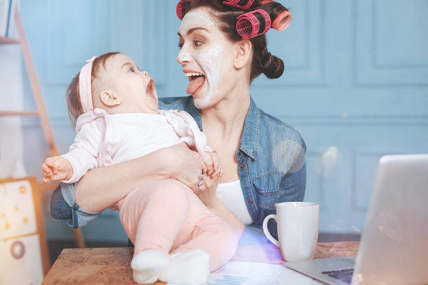 Happy delighted woman having fun with her daughter - Fotoğraf, Görsel