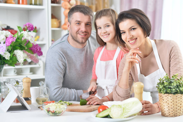 young family cooking together at kitchen - Foto, Imagem