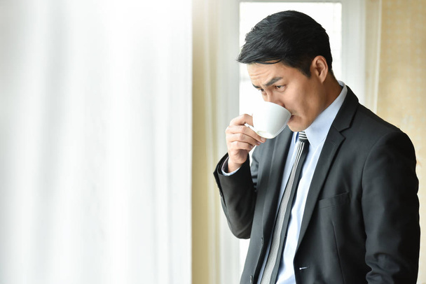 Asian Businessman is  drinking hot coffee. - Foto, Imagem