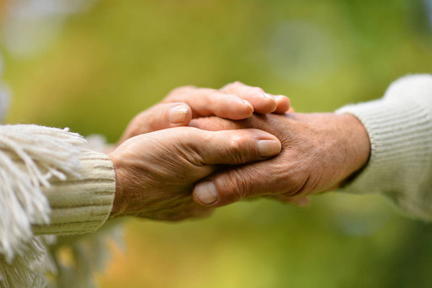 Elderly couple holding hands - Photo, Image