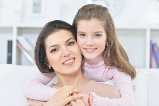 Close-up portrait of a charming girl with mom at home - Foto, Imagem