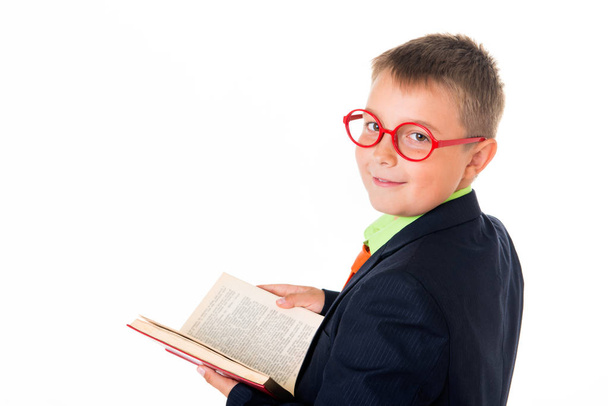 Boy reading a book thirsty for knowledge - isolated over a white background - Foto, Imagem
