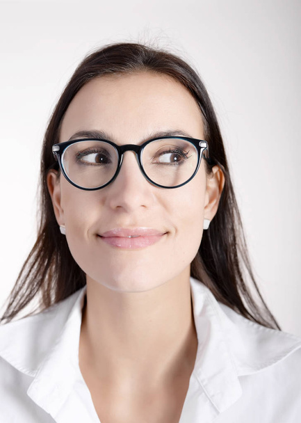 smiling young woman with dark hairs and glasses - Foto, Bild
