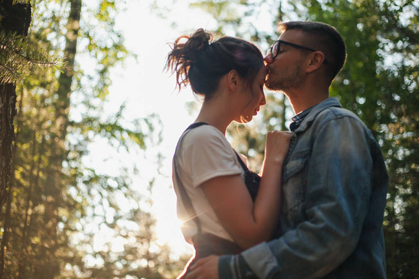 Loving couple kissing outdoor at sunset - Photo, Image