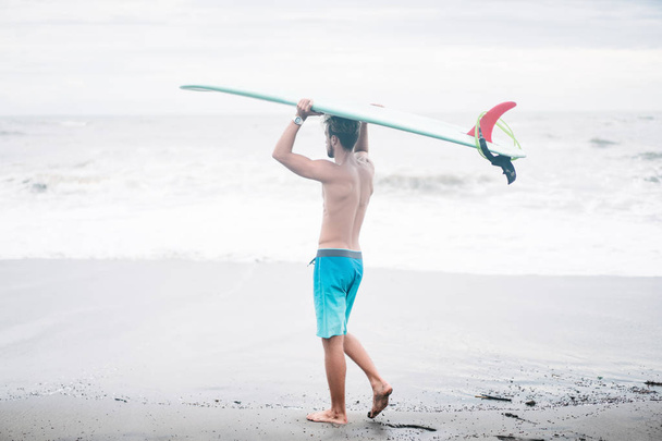 surfboard on head in Bali, Indonesia - Photo, Image