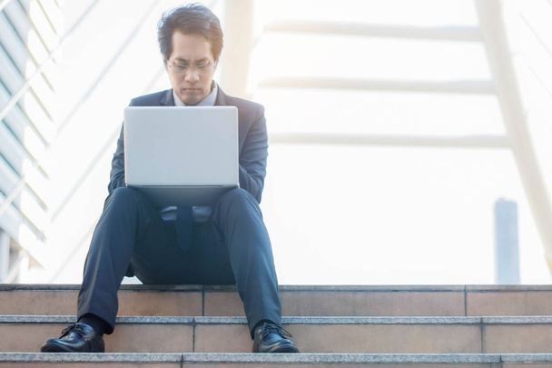 Man sitting and using notebook. - 写真・画像
