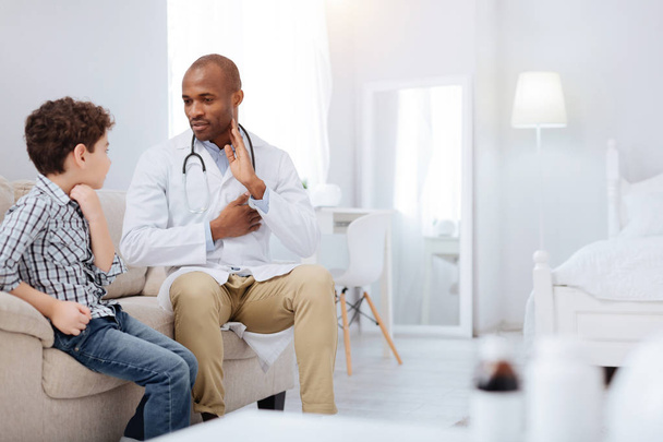 Successful male doctor sharing knowledge with boy - Photo, Image