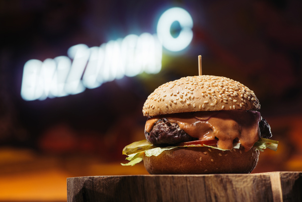 close-up view of delicious beef burger on wooden stump - Photo, Image
