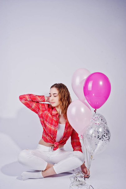 Young girl in red checked shirt and white pants with balloons ag - Foto, Imagem