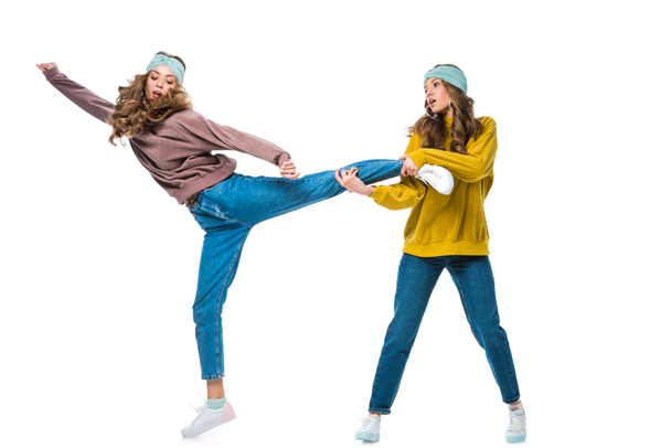 houkutteleva nuori kaksoset tilalla sisaret jalka eristetty valkoinen
 - Valokuva, kuva