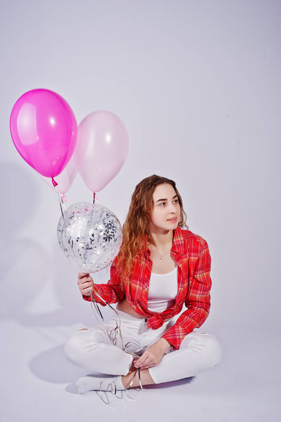 Young girl in red checked shirt and white pants with balloons ag - Fotoğraf, Görsel
