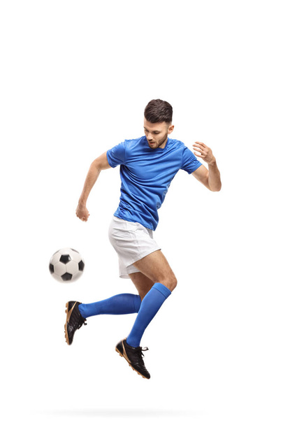 Soccer player doing a trick with a football isolated on white background - Foto, Imagen