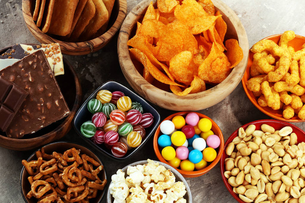 Salty snacks. Pretzels, chips, crackers in wooden bowls. - Photo, Image