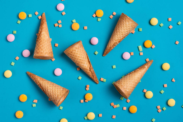 Ice cream cones and sweets over blue background. - Valokuva, kuva