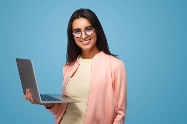 Smart girl with laptop on blue - Zdjęcie, obraz