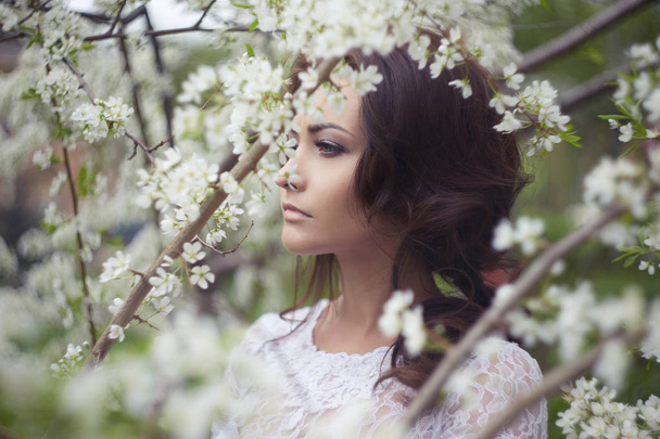 Beauty young woman in Apple-tree flowers - Photo, image