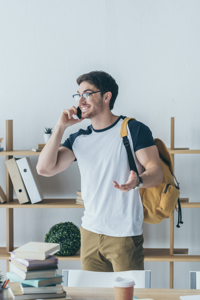 happy male student with backpack talking on smartphone - Foto, Bild