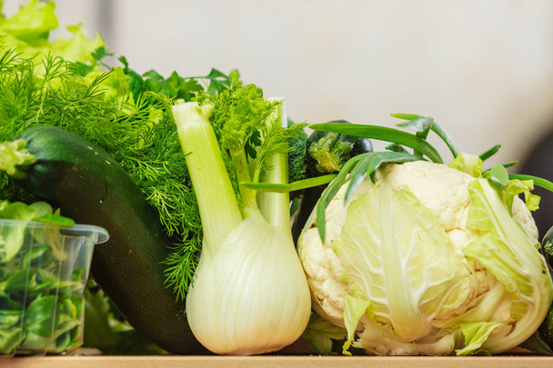 Many green vegetables on kitchen table - Foto, Imagen