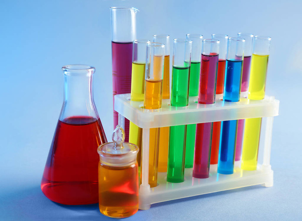 Chemical glassware with samples on color background - Foto, Imagen