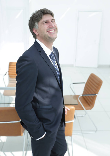 businessman on an empty office background - Фото, зображення