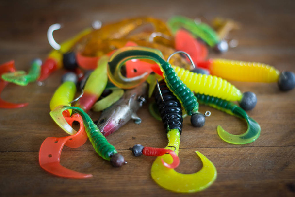 Silicone lures. Twisters on wooden background - Fotografie, Obrázek