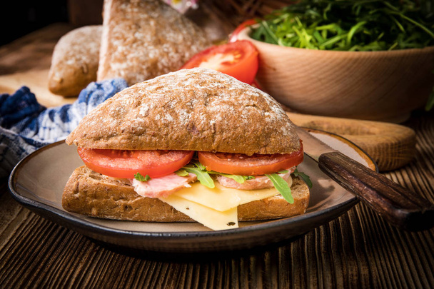 Triangular sandwich with cheese, ham and tomato. - Zdjęcie, obraz