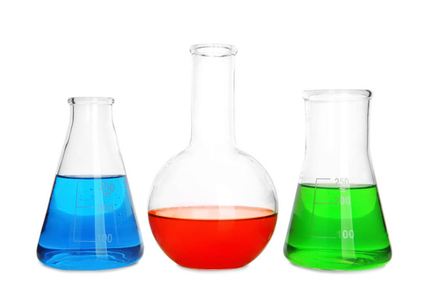Laboratory glassware with liquids on white background - Zdjęcie, obraz