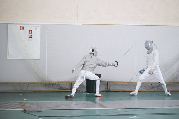 Two teenager fencers practicing their fighting with swords - Photo, Image