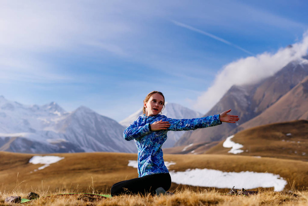 girl engaged in yoga ,Caucasus mountains, travels - Фото, изображение