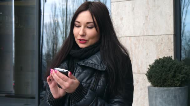 Beautiful Mixed race woman using smart phone technology app walking through city streets urban happy - Felvétel, videó