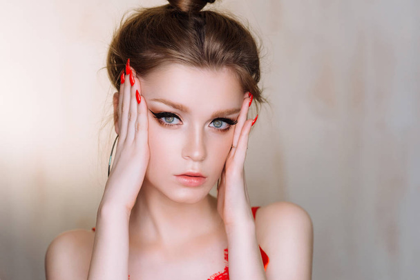 Studio portrait of beautiful young woman posing in red lingerie - Foto, Imagen