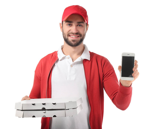Delivery man with cardboard pizza boxes and phone on white background - Photo, Image