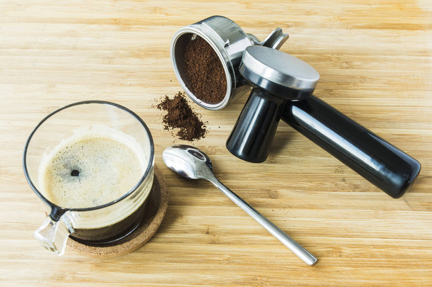 Tasse Espresso auf Holzbrett mit gemahlenem Kaffee - Foto, Bild