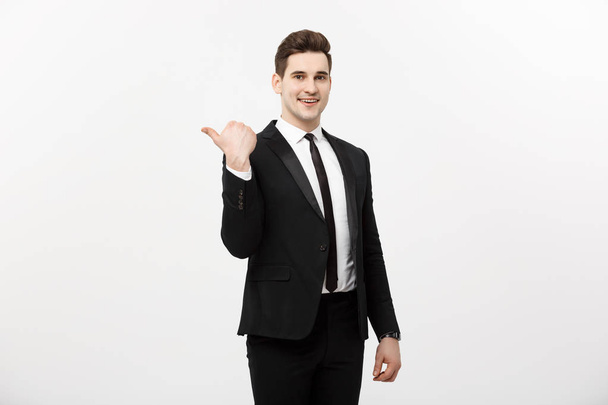 Handsome young business man happy smile point finger to empty copy space, businessman showing pointing side, concept of advertisement product, isolated over white background. - Photo, Image
