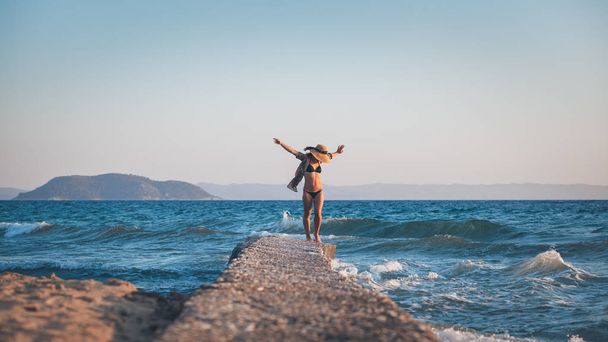 Šťastná mladá žena chodit na molu na pláži - Fotografie, Obrázek