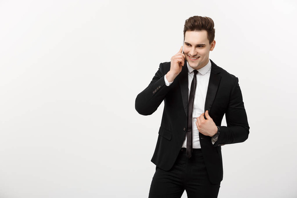 Concept d'entreprise : Portrait d'un homme d'affaires joyeux en costume intelligent parlant sur le téléphone intelligent isolé sur un fond blanc
 - Photo, image