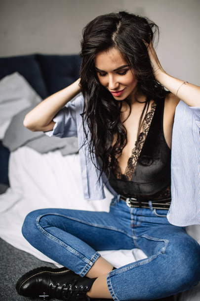 cute young woman sitting on the floor in blue jeans and blue shirt, fashion - Foto, immagini