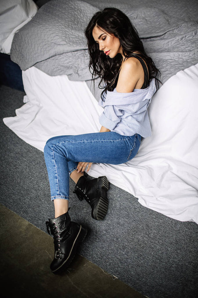 cute young woman sitting on the floor in blue jeans and blue shirt, fashion - Valokuva, kuva