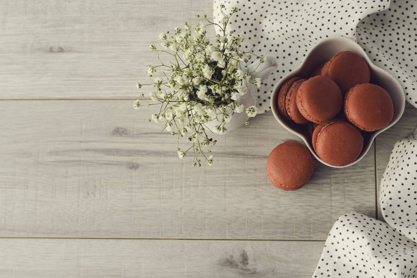 Tasty macarons in a stylish bowl on white marble background. Minimalist concept of style and french chic and selective focus. - Photo, Image